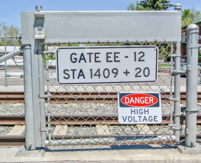 Custom fabricated gate with nameplate and safety signage